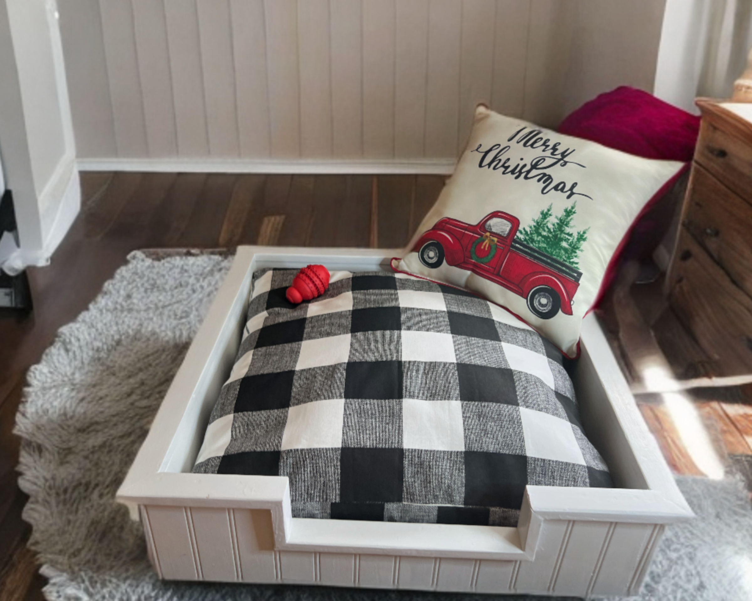 Buffalo Plaid Black and White Pet bed  and Christmas-themed pillow in a home setting, Seasonal Dog Bed, wood dog bed frame, dog bed furniture