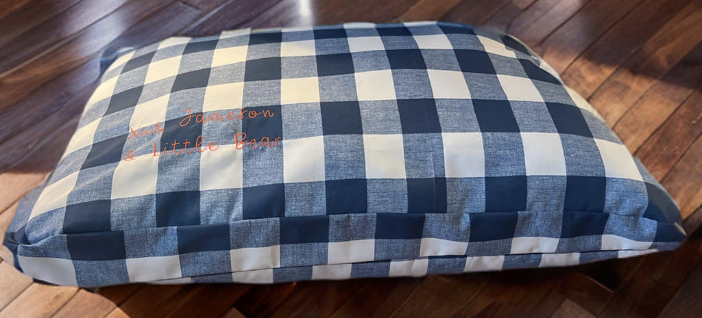 Blue and white checkered pet bed on a wooden floor, Personalized Dog Bed, DOg Bed with Name, Embroidered Dog Bed, Dog Bed Amazon, Dog Bed Cover, Dog Bed Large, dog beds for small dogs, personalized dog bed cover, personalized dog bed crate,  dog bed with removable washable cover, cutest dog bed,  cute dog bed for girls, Modern dog Bed, industrial dog beds, dog beds to match home, gifts for pet lovers, Christmas gifts for pets, holiday pet gifts,