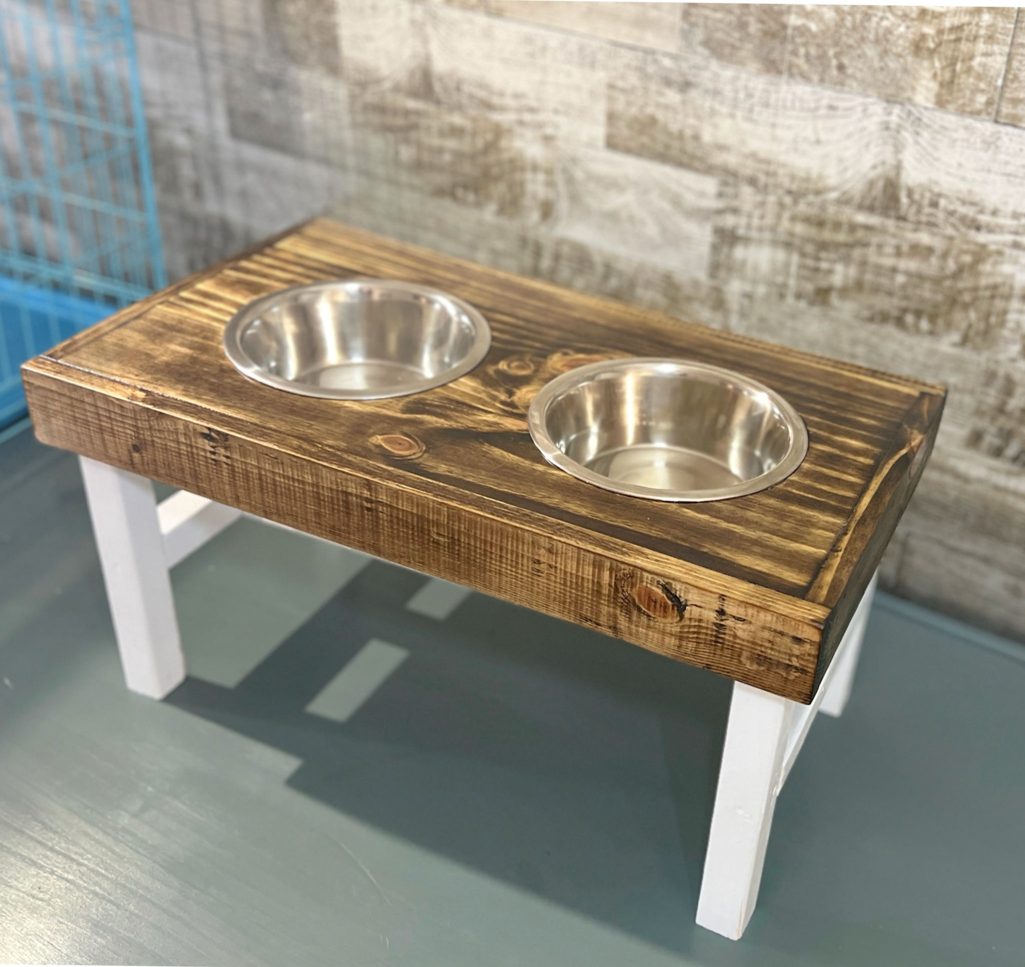 Wooden pet feeding station with two bowls on a wooden floor. Raised dog bowl stand, dog bowl holder, large dog bowl stand, small dog bowl stand, wooden dog bowl stand raised, elevated pet bowl stand, elevated dog bowl stand, dog bowl stand wood,
